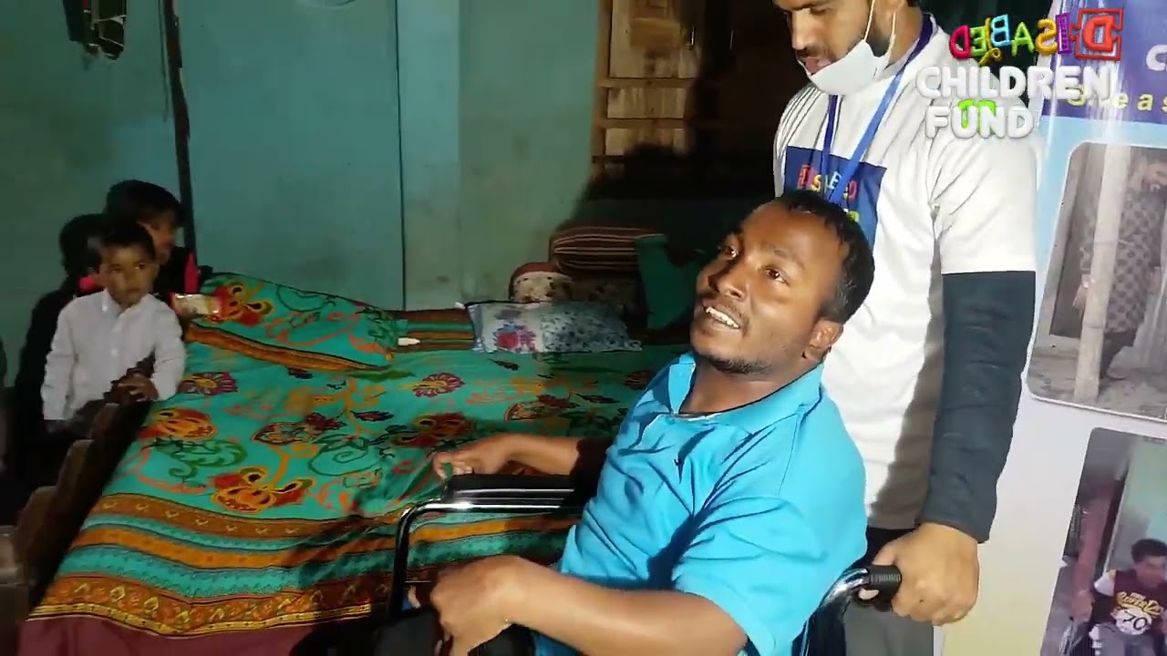 Abu Hassan receiving a wheelchair
